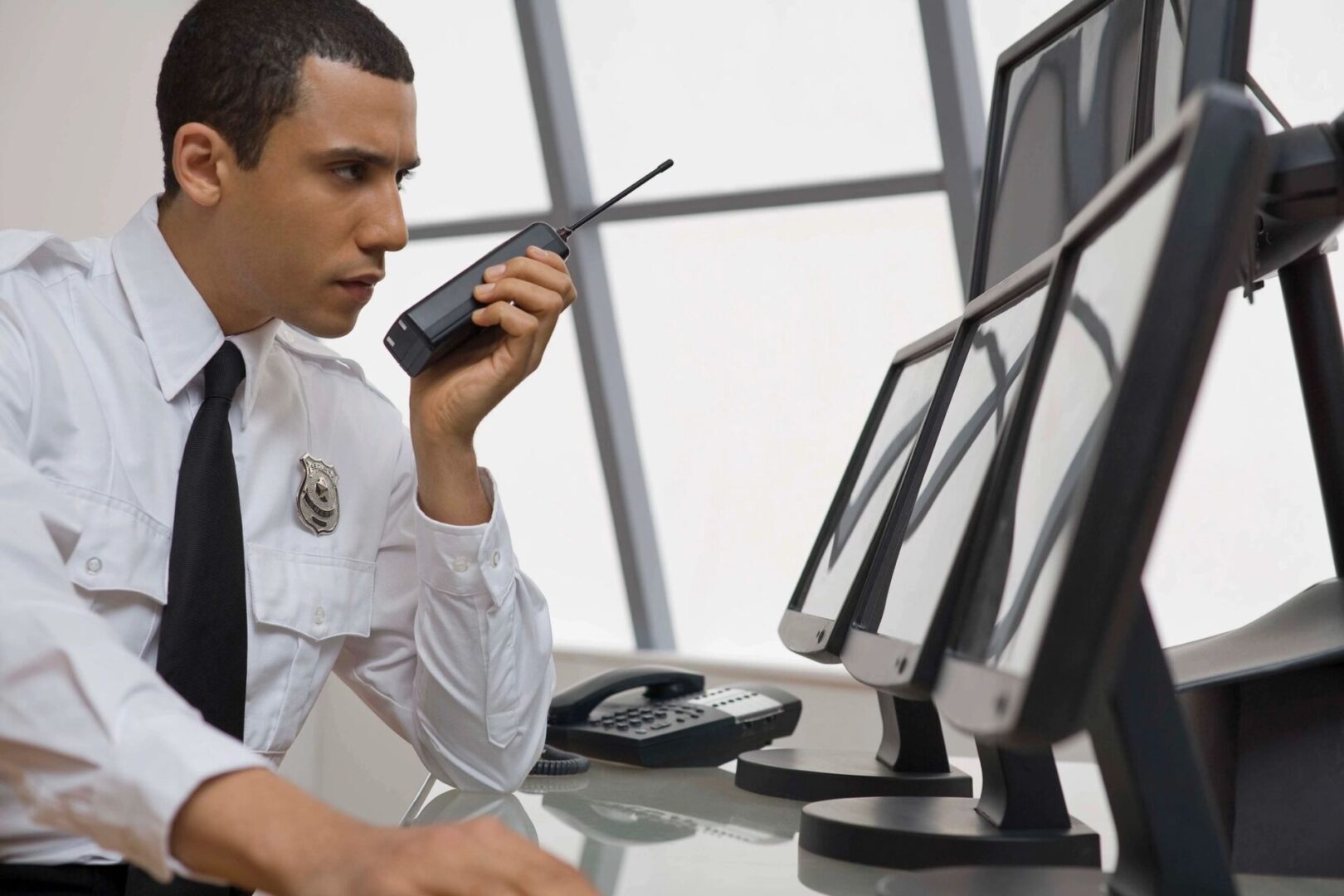 A man sitting at his desk talking on the phone.